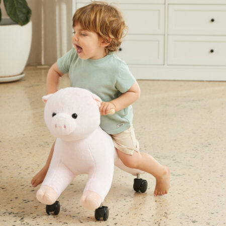 Child riding soft pig roller toy on wooden floor – TLRC225